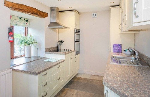 Fence Cottage | An 1800’s barn conversion with beams, exposed stonework and flagged floors.