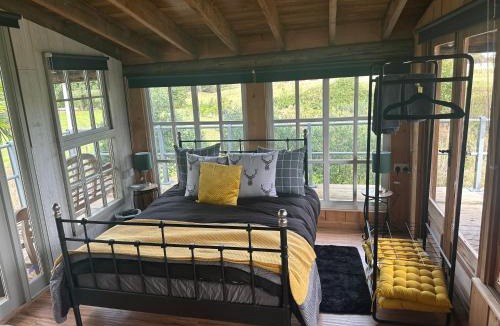 East Drayton Cabin | Escape to the Country, Lodge, Retreat, Cabin over small river, private hot tub & log burner, WiFi, 65 inch smart TV relax read at Weston Newark, Nottinghamshire