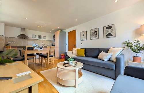 Chinatown Apartment | Stylish 2-bed flat sleeps 6. Double ensuite + bunk room, open-plan kitchen/lounge with sofa bed & TV. Private parking. 15min walk to Etihad Stadium, 6min drive to Piccadilly Station. Perfect for groups!