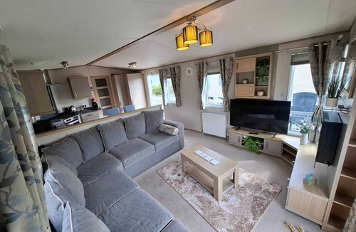 Grimsby House | Unwind in our stunning premium waterside retreat. Full wraparound decking