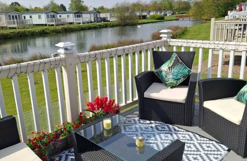 Grimsby House | Unwind in our stunning premium waterside retreat. Full wraparound decking
